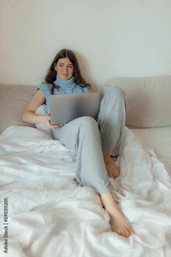 Young woman posing in the bedroom, have fresh glow make up, laptop sitting at home write messages. Technology and content marketing concept. Young woman posing in the bedroom, have fresh glow make up, laptop sitting at home write messages. Technology and content marketing concept.