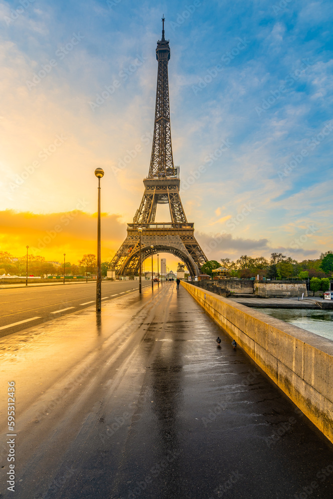 Eiffel tower from Jena Bridge, French: Pont d Iena. Beautiful sunrise after rain in Paris, France.