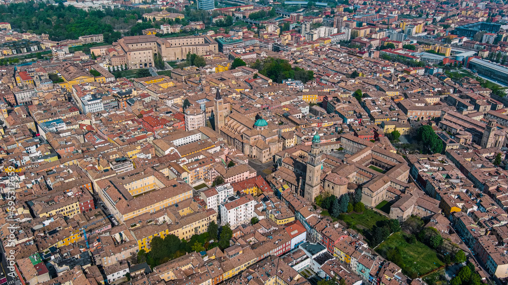 Aerial view of Parma is a university city in Italy's Emilia-Romagna region. Romanesque buildings, inc. the frescoed Parma Cathedral with the pink marble Baptistery in city center from above 5.5K UHD