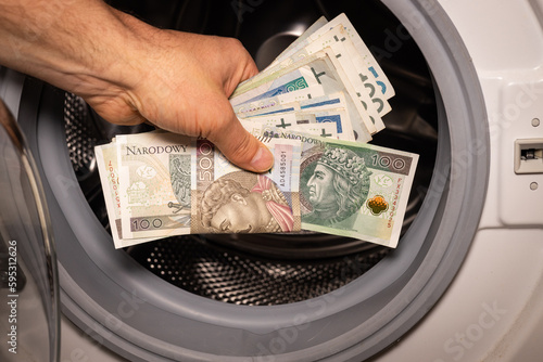 Polish money thrown into the washing machine, Concept, Money laundering, Illegal activity proceeds, Dark business, Black market, Bundle of top series banknotes