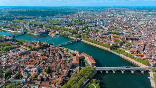 Toulouse city and Garonne river aerial panoramic view. It's the capital of southern France Occitanie region. Historical landmark Dome de La Grave from above in Haute Garonne on a summer day 5.5K UHD photo