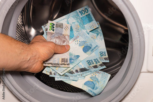 Brazilian money in the washing machine, Concept, Money laundering, Illegal business, Black market Reais, criminal activity