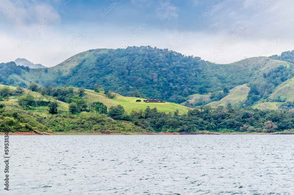 A view of the hillside above the shoreline of the Arenal Lake in Costa Rica during the dry season