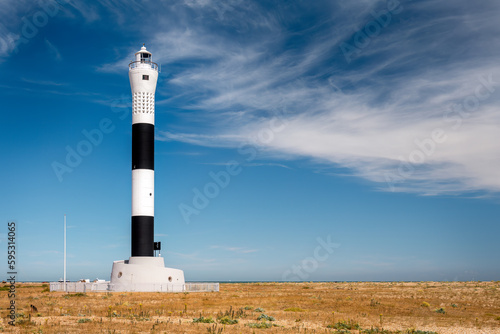 Fifth Dungeness lighthouse still in use, black and white, on a summer afternoon, Kent, England