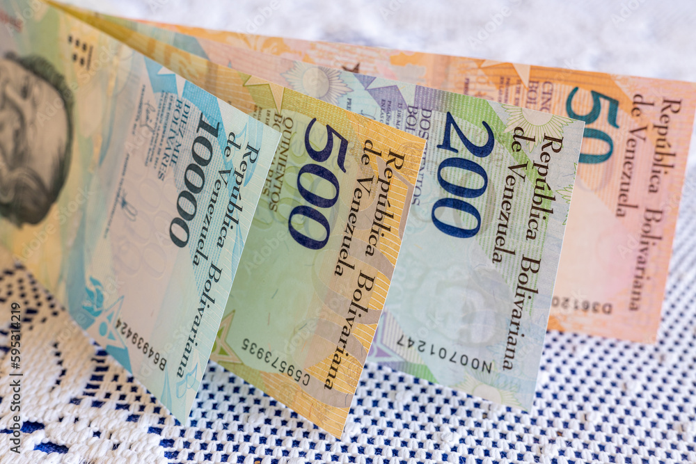 Obraz premium Venezuela money, Bolivares banknotes on white tablecloth at home, Household expenses and family budget concept