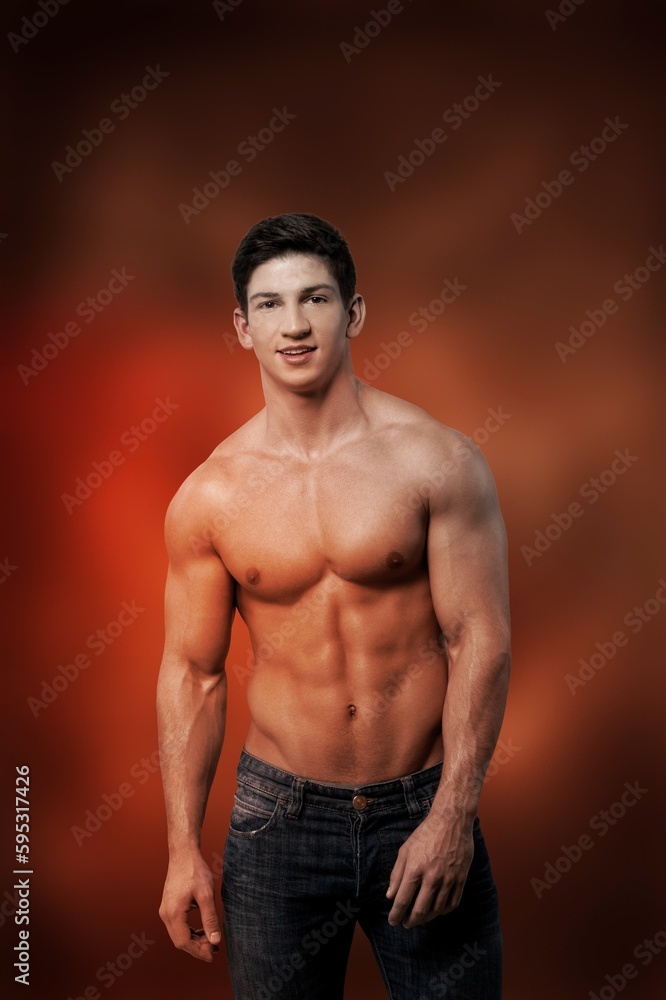Fototapeta premium Young muscled man posing is studio.