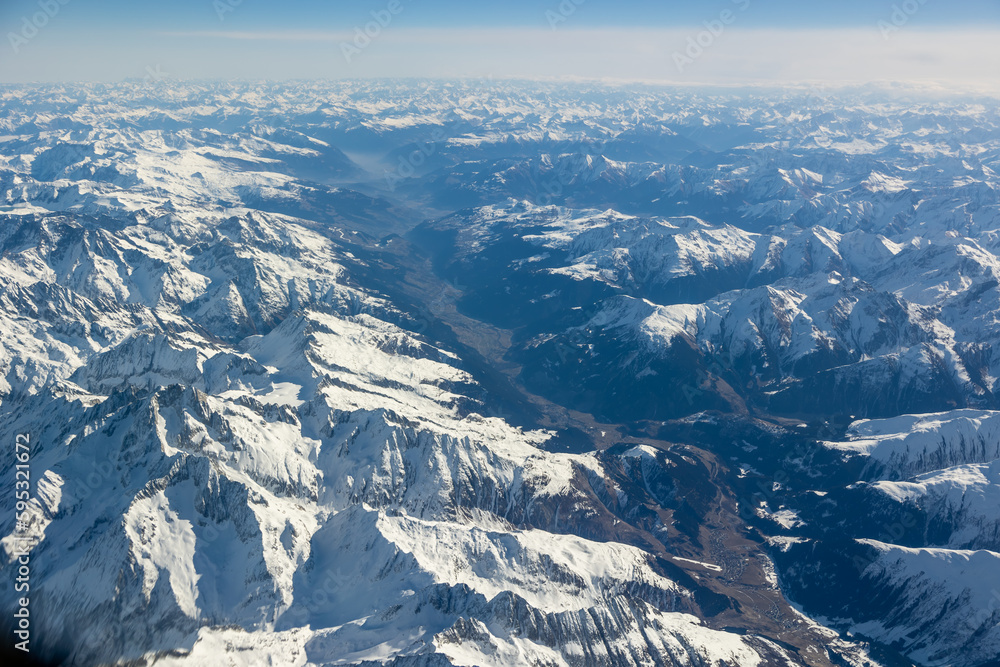 Aerial image of the Alps in full sunlight with lots of snow