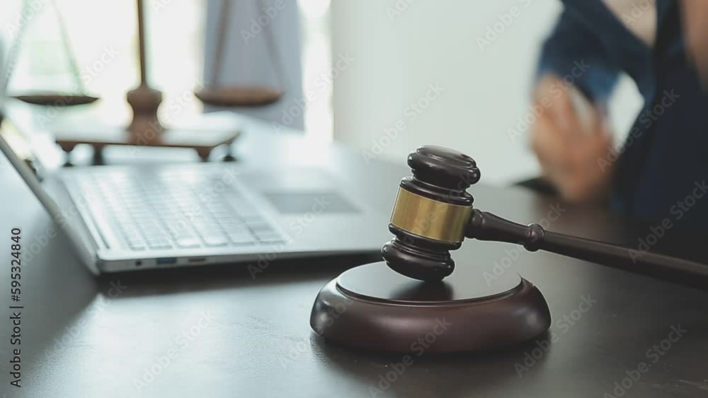 Business and lawyers discussing contract papers with brass scale on desk in office. Law, legal services, advice, justice and law concept picture with film grain effect Business and lawyers discussing contract papers with brass scale on desk in office. Law, legal services, advice, justice and law concept picture with film grain effect