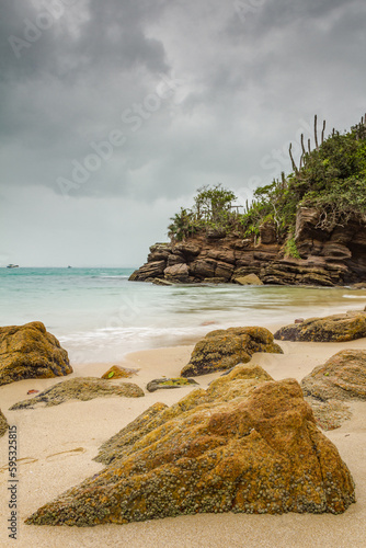 Bucolic landscape with beach on a cloudy day in the touristic city of Armação dos Buzios, coastline of Rio de Janeiro, Brazil.