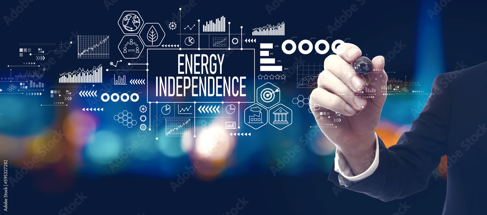 Energy Independence concept with businessman in a city at night Energy Independence concept with businessman in a city at night