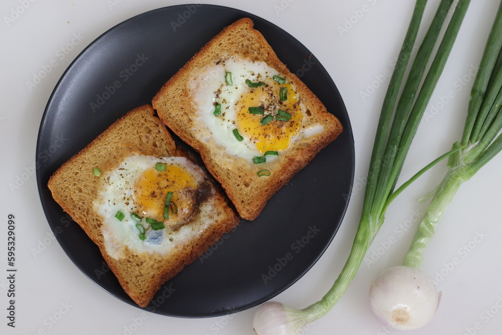 Bulls eye on bread toast. Egg fried in a hole made in the center of the toast Bulls eye on bread toast. Egg fried in a hole made in the center of the toast
