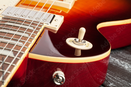 electric guitar pickup selector on wood background