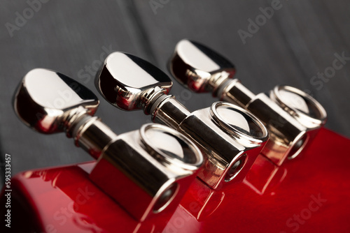 electric guitar tuning machines on wood background