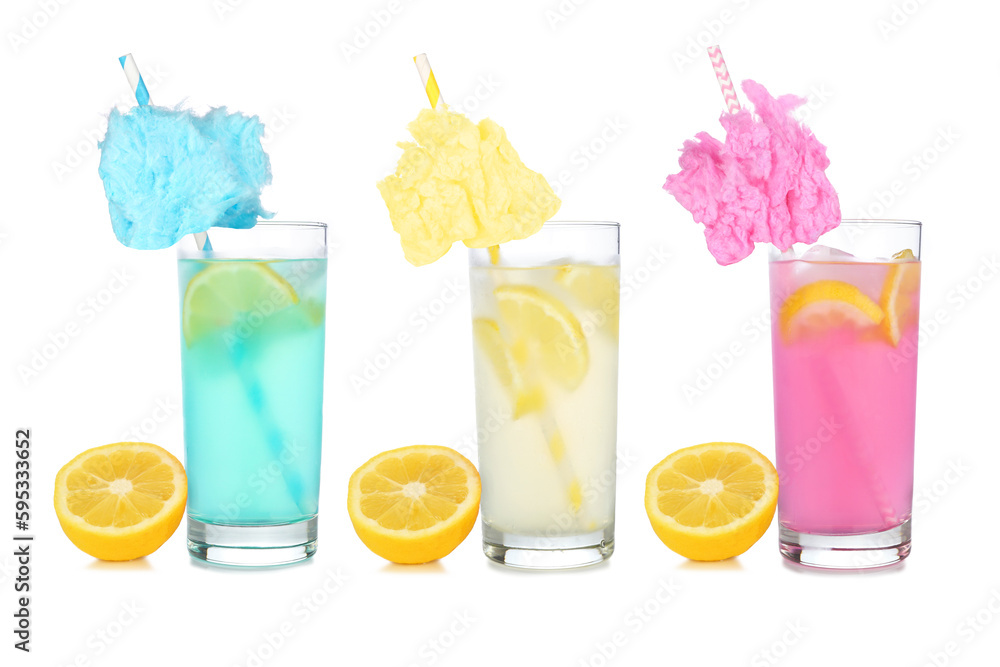 Cold, colorful cotton candy lemonade summer drinks. Three colors in tall glasses with lemons isolated on a white background. Cold, colorful cotton candy lemonade summer drinks. Three colors in tall glasses with lemons isolated on a white background.