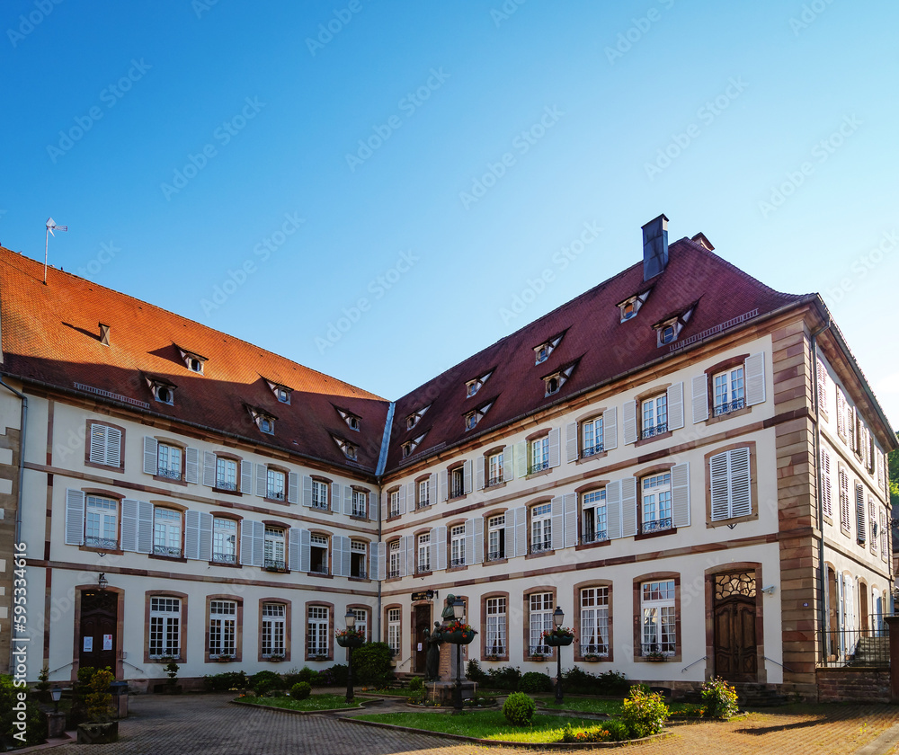 Fototapeta premium Gorgeous old multistory building. Sunny day, beautiful architecture of the past.