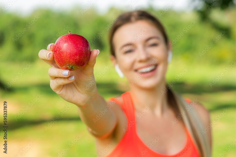 Beautiful sporty girl after a workout. Focus on Apple. Beautiful sporty girl after a workout. Focus on Apple.