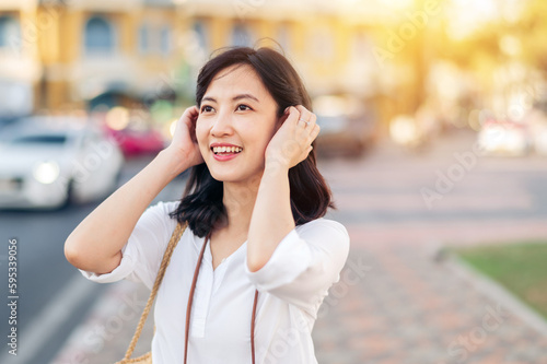 Portrait beautiful asian woman traveler smiling while explore street on summer vacation in Bangkok, Thailand