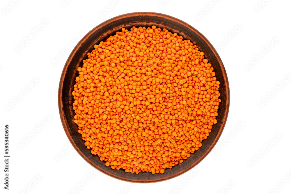 Red lentils on a clay dish, macro, isolated on a white background, top view. Red lentils on a clay dish, macro, isolated on a white background, top view.