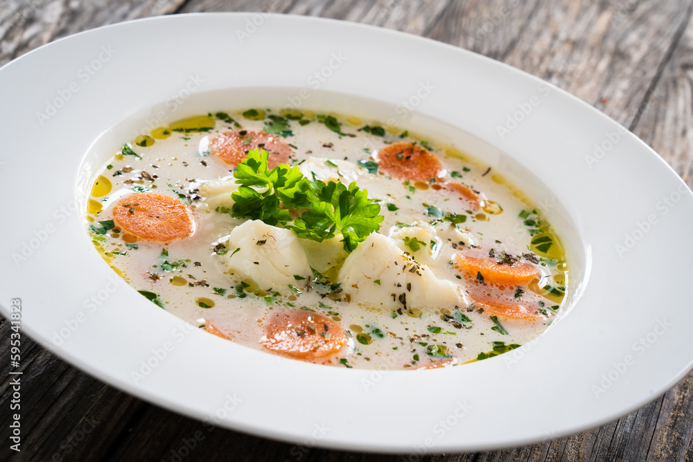 Fish soup on wooden table
