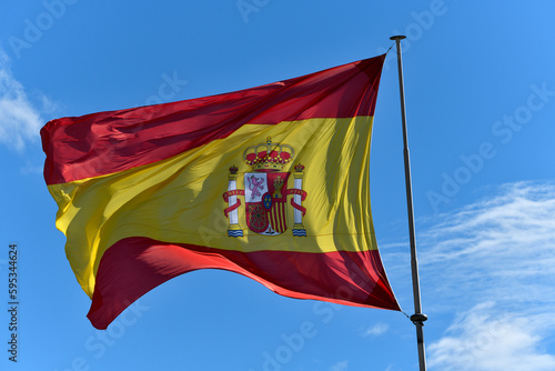 Bandera de España ondeando al viento photo