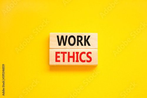 Work ethics symbol. Concept words Work ethics on beautiful wooden block. Beautiful yellow table yellow background. Business and Work ethics concept. Copy space.
