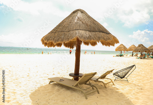 palapa sun roof beach umbrella by the beach symbolizes relaxation, shade, and protection. It represents a tropical, beachy atmosphere and the desire to escape from the sun's harsh rays