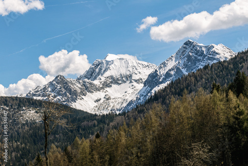 Snowy mountains with blue heaven and big clouds