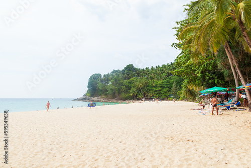 Fototapeta Naklejka Na Ścianę i Meble -  Beautiful Surin beach in Choeng Thale city, Phuket, Thailand with white sand, turquoise water and palm trees