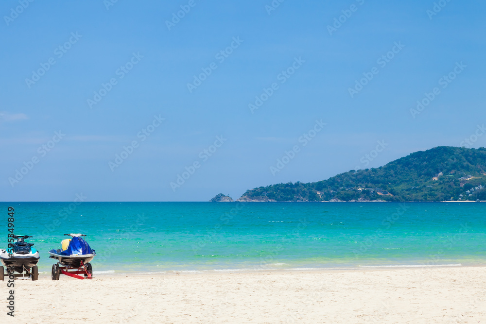Beautiful Patong beach in Phuket, Thailand with white sand, turquoise water, jet skis and palm trees Beautiful Patong beach in Phuket, Thailand with white sand, turquoise water, jet skis and palm trees