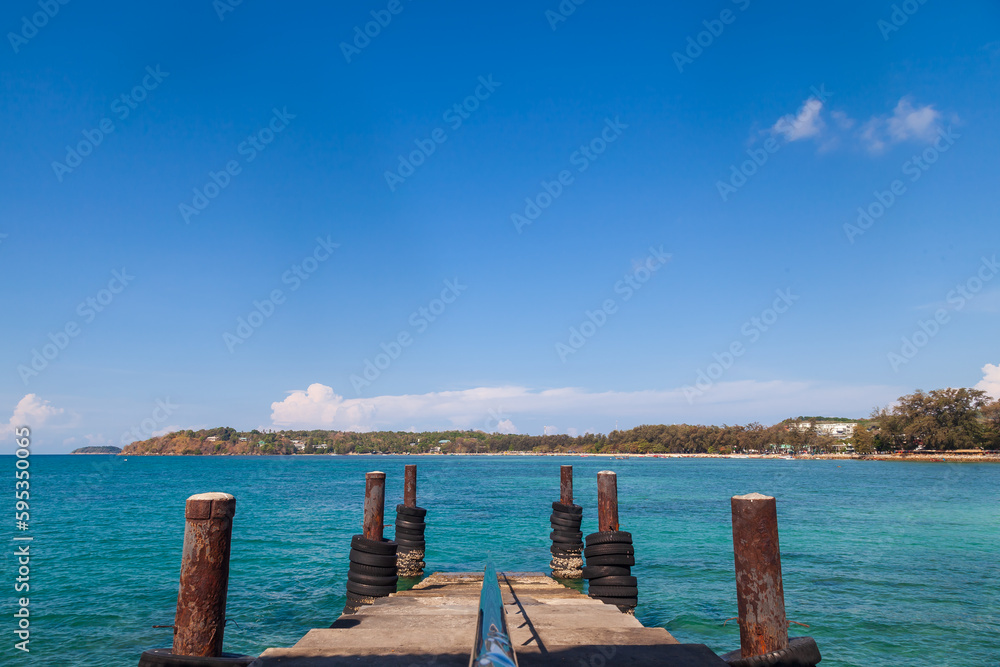 a picturesque pier at the rafai beach pier going under water with steps. Clear turquoise water and blue sky. Travel and recreation. a picturesque pier at the rafai beach pier going under water with steps. Clear turquoise water and blue sky. Travel and recreation.