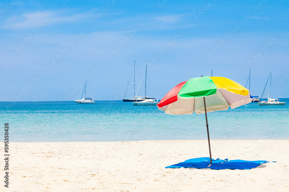 beautiful bright nai harn beach in thailand on phuket island with clear turquoise water in the sea, white sand with umbrella and blue sky. A popular tourist place in the hot countries of Asia.