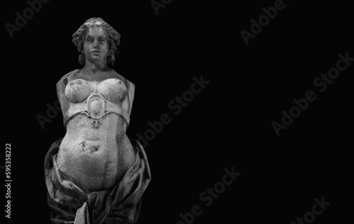 The goddess of love in Greek mythology  Aphrodite  Venus in Roman mythology  Fragment of ancient statue against black background. Copy space.