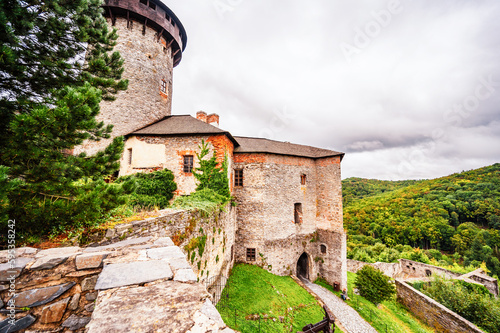 Castle Sovinec, Eulenburg, robust medieval fortress, one of the largest in Moravia, Czech republic. landscape with medieval castle on a rocky hill above a forest valley photo