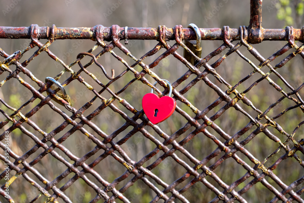 Love Padlocks on Bridge Railing. metal love padlocks with heart decoration. Traditional heart-shaped lock as a symbol of eternal love.