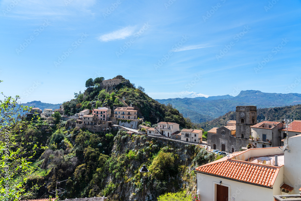 ancient Sicilian village of Savoca, with Mount Etna volcano in the background
