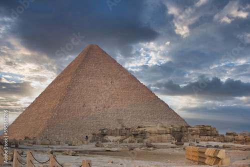 The Pyramid of Cheops in Giza at sunset surrounded by clouds