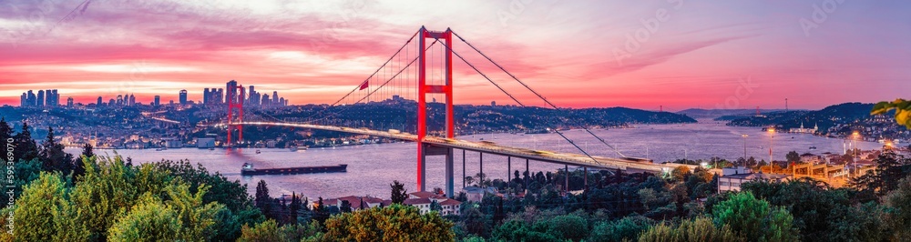 Obraz premium Awesome Panoramic view of Istanbul Bosphorus on sunset. Istanbul Bosphorus Bridge (15 July Martyrs Bridge. Turkish: 15 Temmuz Sehitler Koprusu). Beautiful landscape Turkey.