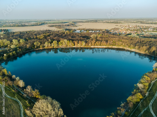 Bird's eye view of the lake and forest. Spring nature. View from a drone.