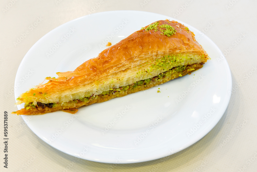 Turkish Dessert Sobiyet Baklava, mussels baklava and classic baklava with Pistachio . Didye, Cevizli, Fistikli Baklava, top view. Turkish Dessert Sobiyet Baklava, mussels baklava and classic baklava with Pistachio . Didye, Cevizli, Fistikli Baklava, top view.