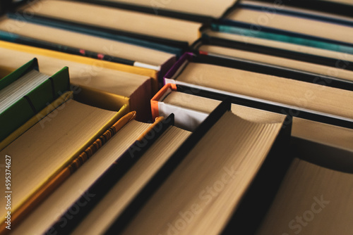 Background: set of books standing one by another, look from above