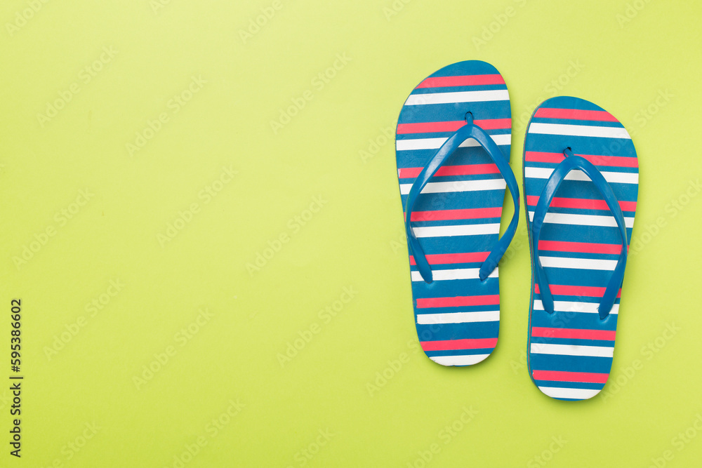 Bright flip flops on color background, top view Bright flip flops on color background, top view