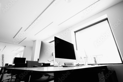 Blank white computer monitors on light wooden table with modern keyboard in stylish office © AvokadoStudio