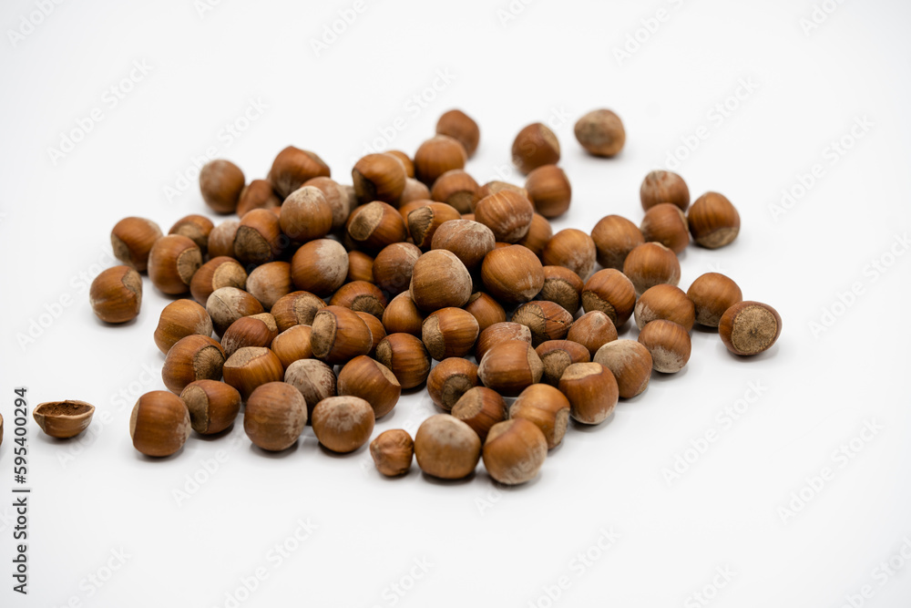 Pile of hazelnuts in a shell on white background Pile of hazelnuts in a shell on white background
