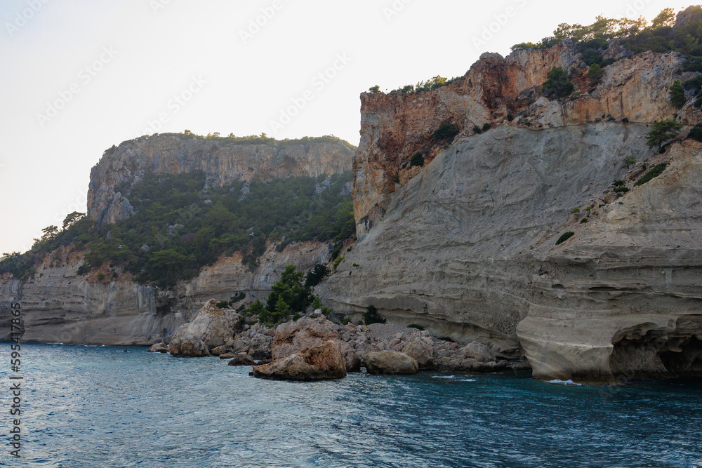 View of the rocky shore from the sea. Mediterranean Sea in Turkey. Popular tourist places. Background