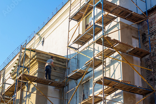 Builder on the scaffolding works on the restoration of the monastery in the Baroque style