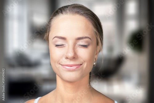 Portrait of young woman posing on background