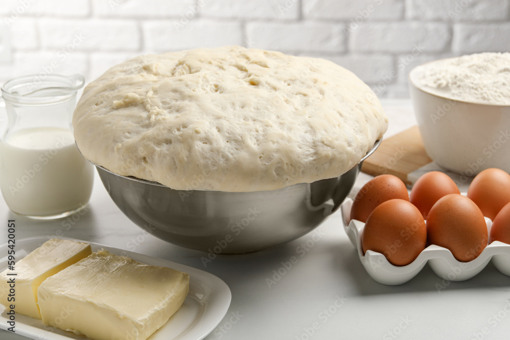 Fototapeta premium Fresh yeast dough, eggs and ingredients on white table. Making cake