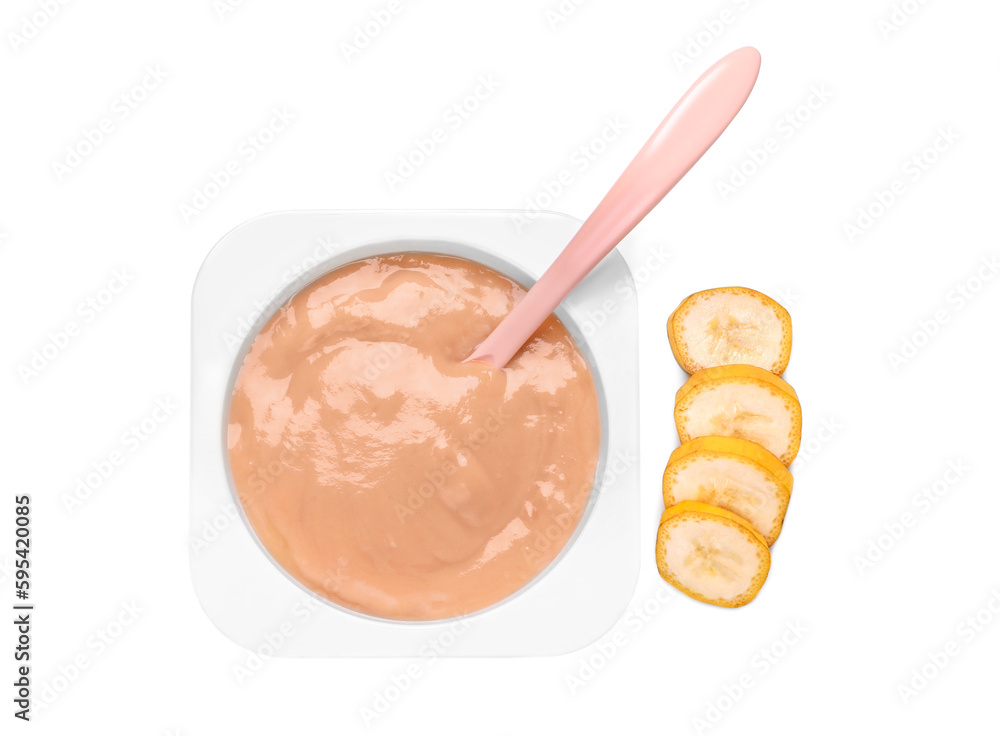 Container with healthy baby food, spoon and banana isolated on white, top view Container with healthy baby food, spoon and banana isolated on white, top view