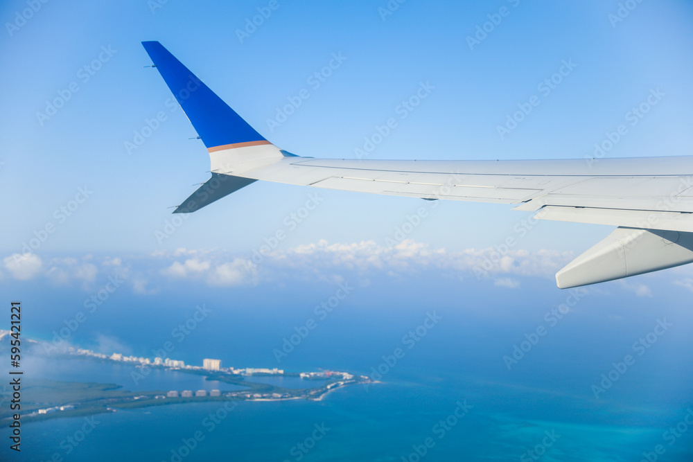 aerial view from a window seat captures the majestic airplane wing soaring through the clouds, symbolizing freedom, adventure, and travel. The view offers a sense of perspective