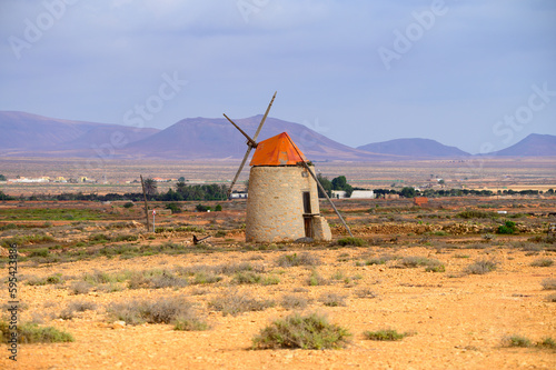 Old traditional Canarian grain wind mill near Antigua village, countryside landscape of Fuerteventura island, Spain